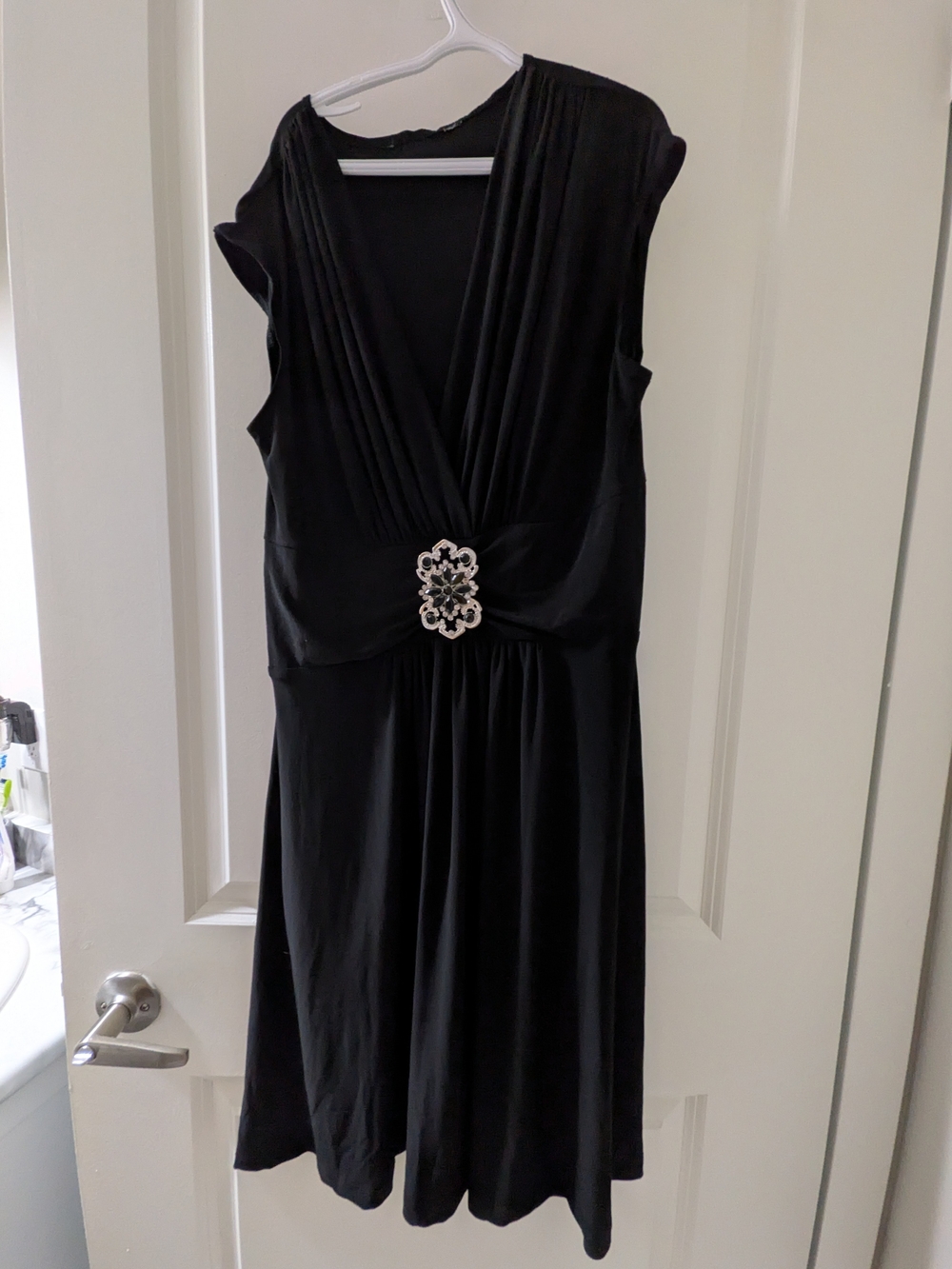 Elegant Black V-Neck Dress with Decorative Brooch